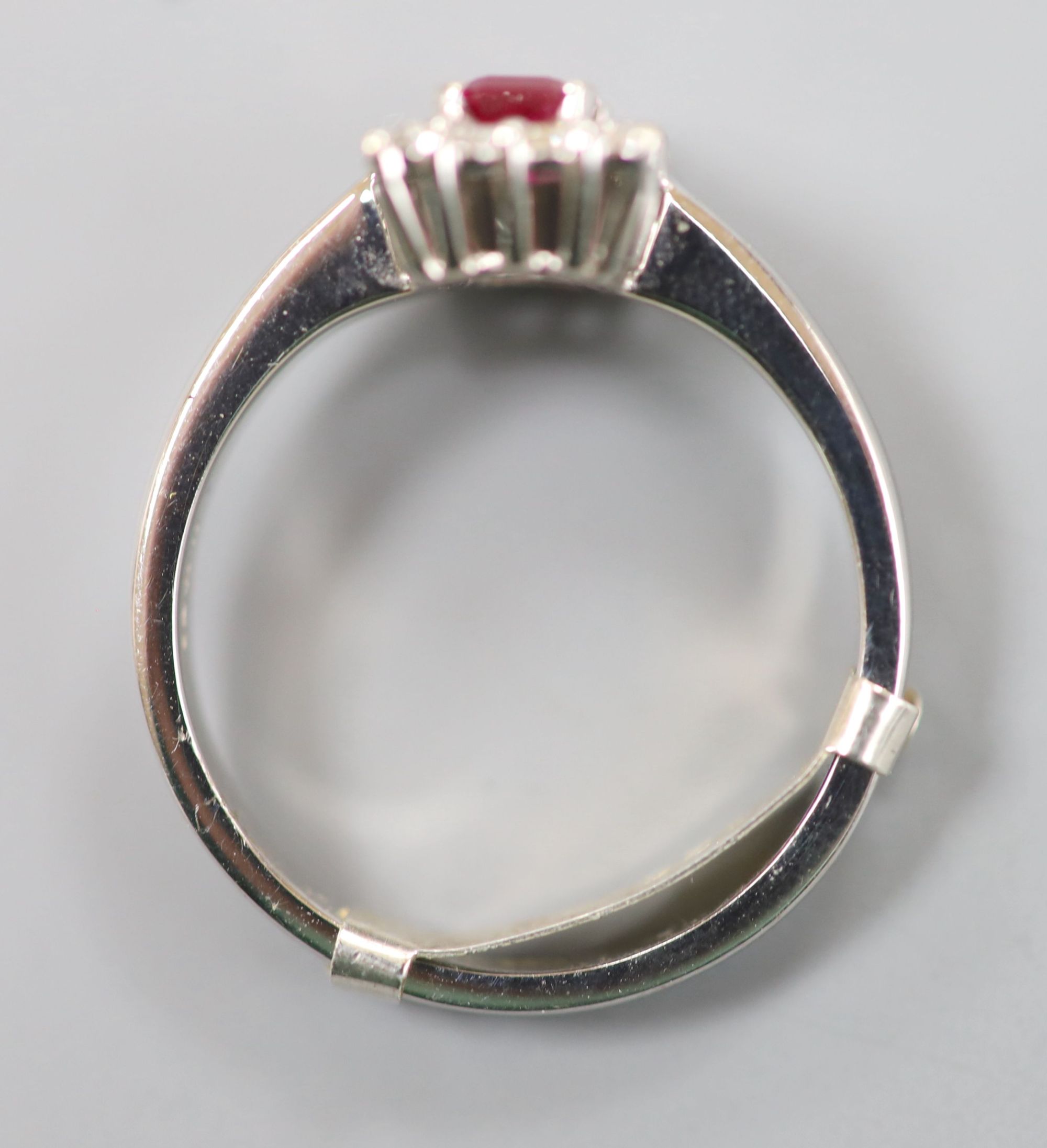 A modern 18ct white gold, ruby and diamond set rectangular cluster ring, size P/Q, gross 6 grams.